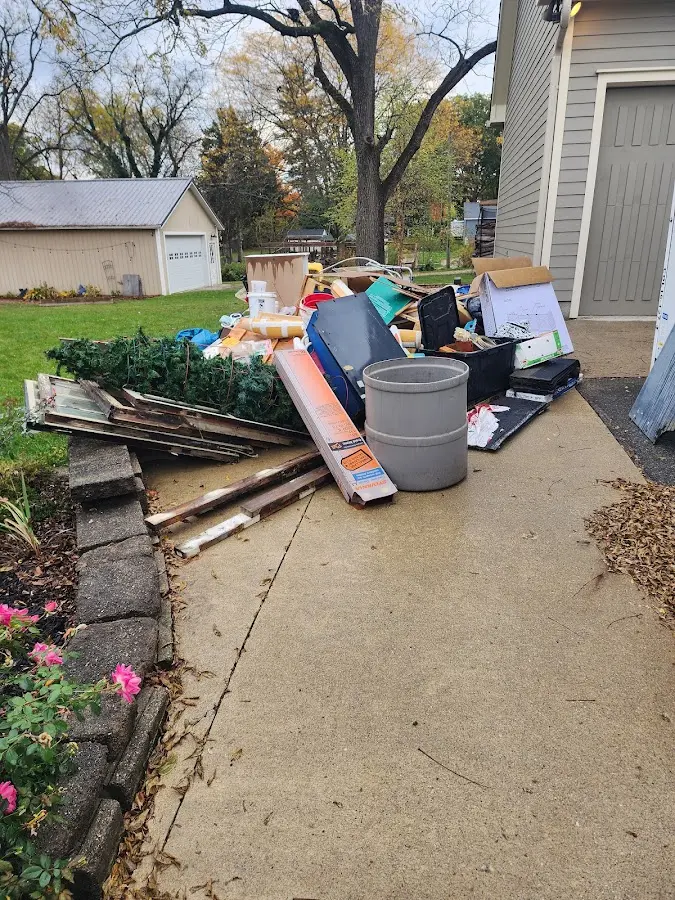 Dumpster being loaded with debris for Estate Cleanout Dumpster Rental in Louisville